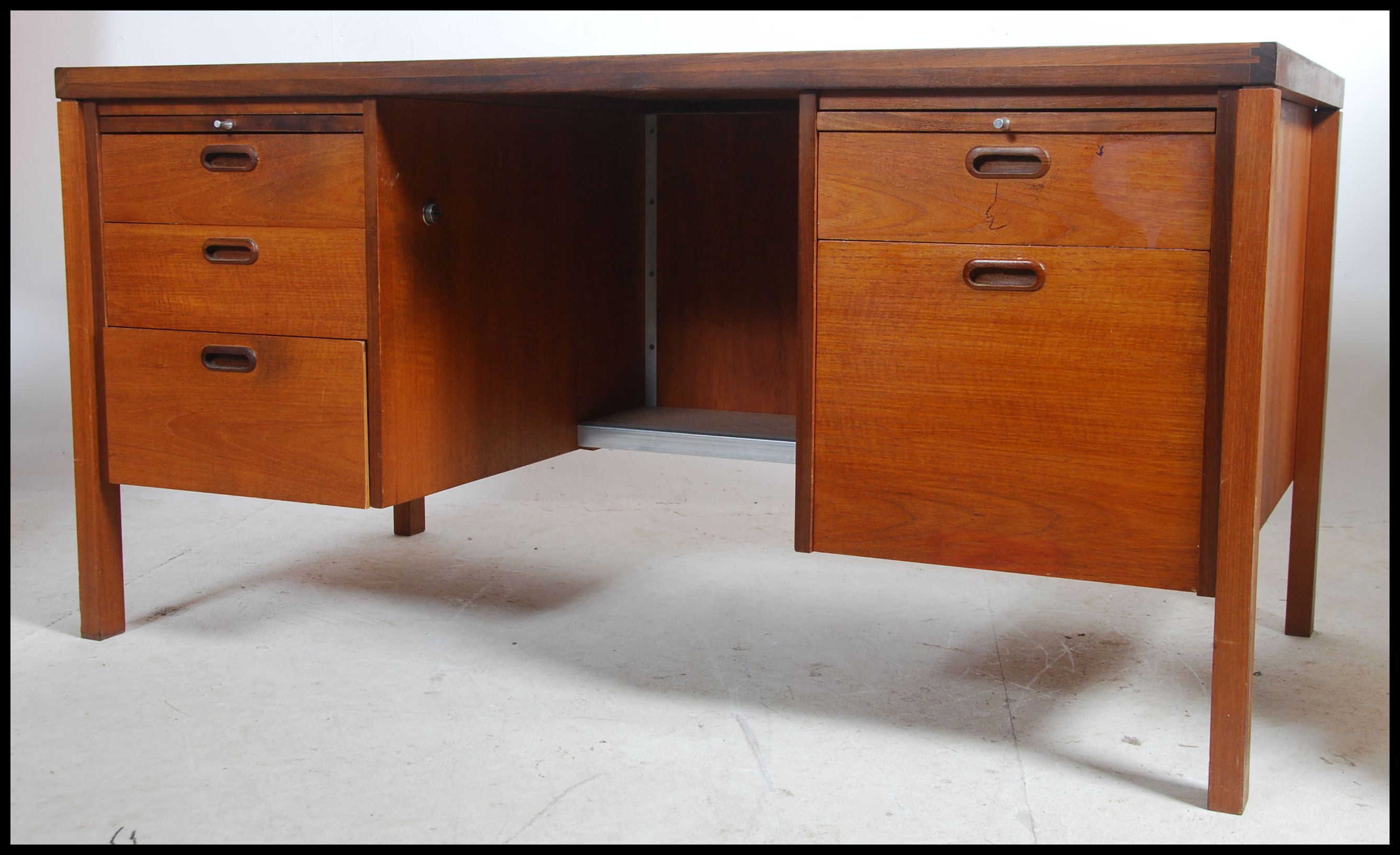 A 1970's good Danish inspired teak wood twin pedestal office desk being raised on squared legs