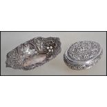 An eastern silver snuff box having squeeze side opening. Chased with flowers etc of lozenge form.