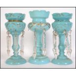 A collection of 3 19th century Victorian blue glass table lustres, each with gilded decoration