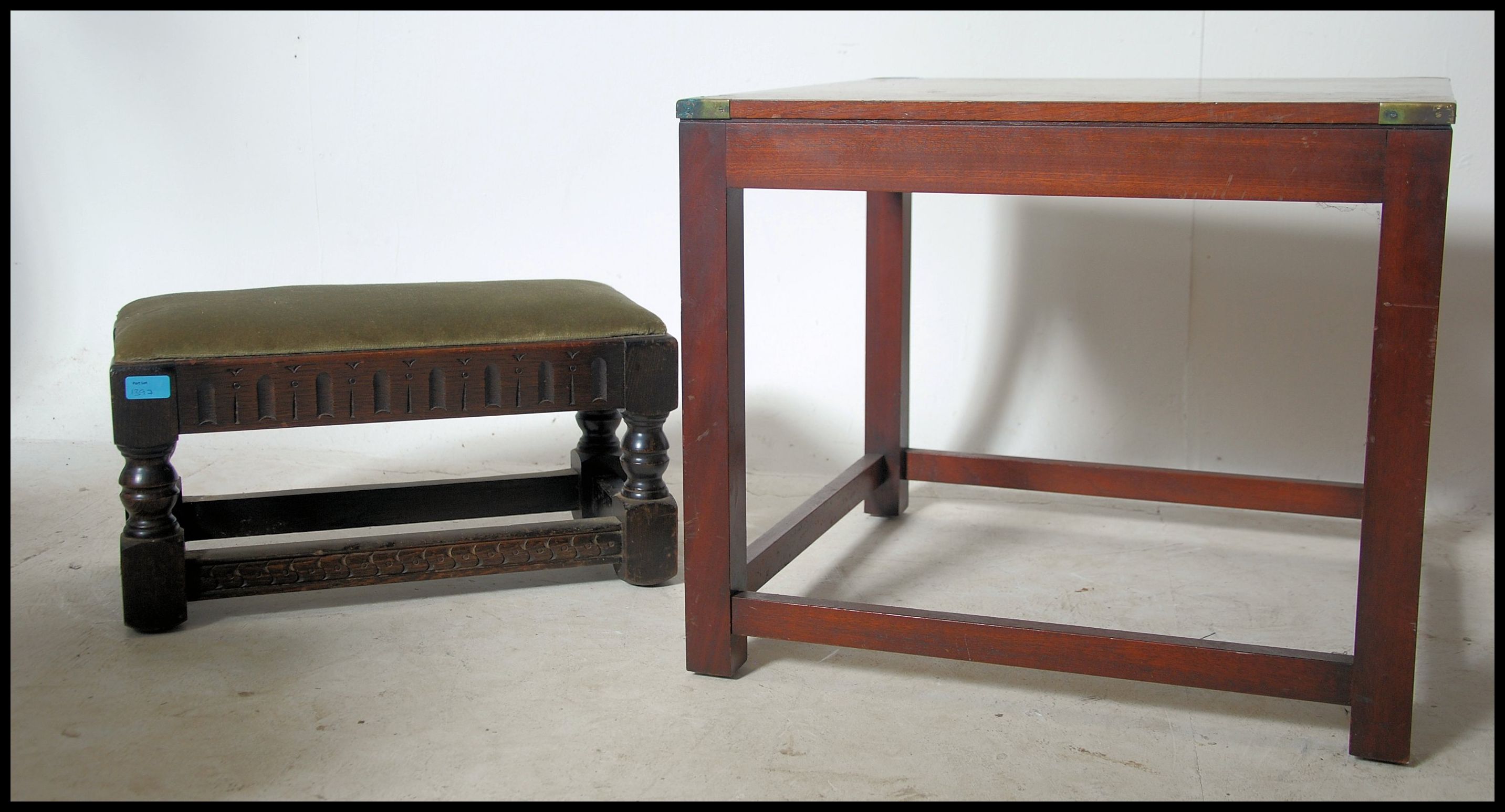 A mahogany and brass bound campaign style square coffee - occasional table being raised on sqaured