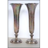 2 silver hallmarked solifleur vases with scalloped tops on tapering shafts with terraced feet.