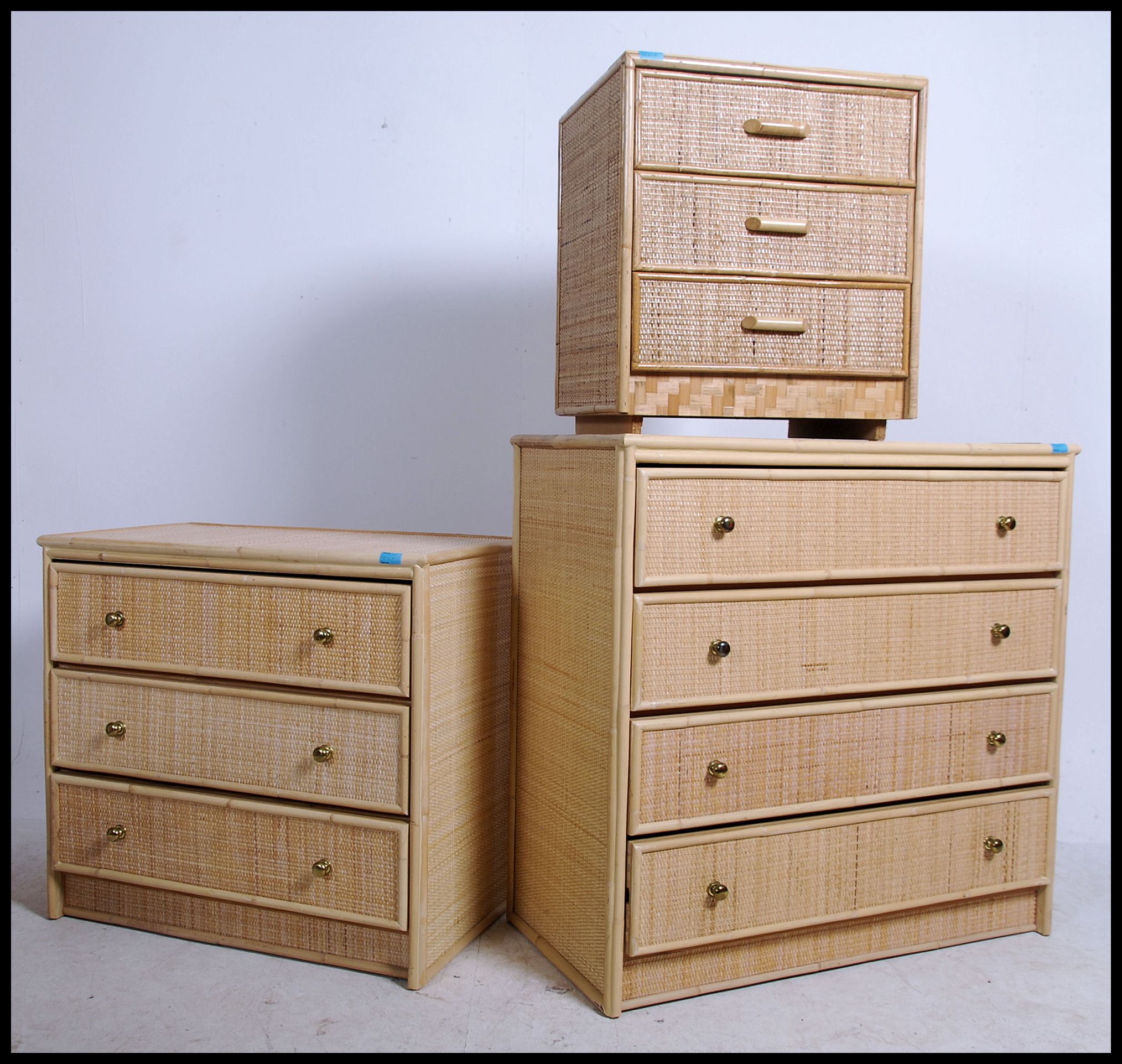 A set of three graduating 20th century whicker effect chest of drawers. Each Chest of drawers having