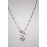 A silver bead / ball necklace and pendan