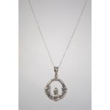 A silver necklace chain and pendant in t