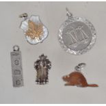 A collection of 5 silver charms to inclu