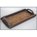 A 19th century carved in relief oak tray. Carved i