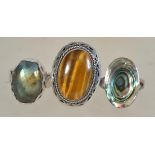 A group of three silver 925 dress rings to include one set with a large central tigers eye stone,