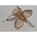 A fantastic pierced fretwork filigree silver brooch in the form of a cymbidium orchid having a