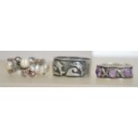 A silver 925 ladies band ring with leaf pattern set with purple stones along with another silver
