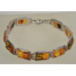 A silver 925 panel bracelet with interlocking rectangular lozenges with amber type coloured stones