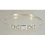 A silver 925 bangle bracelet with belt buckle design having central clear stone and hidden clasp.