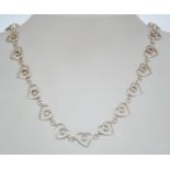 A silver 925 heart linked necklace chain having a C clasp and adjustable length. Chain measures 16