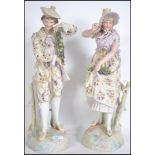 A pair of late 19th century  French bisque figures of a lady and gent A/F. Measures 54cm high.