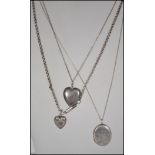 A collection of 3 silver lockets and necklace chains. A silver oval locket, hallmarked silver