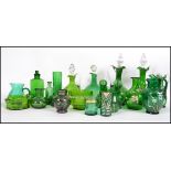 A collection of decorative green glass to include a good Mary Gregory cameo vase together with other