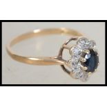 A 9ct gold hallmarked sapphire and diamond ring having a central oval sapphire stone with illusion