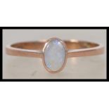 A 9ct gold and opal ladies ring. The central oval cut opal. Maker SA, Believed London hallmark being