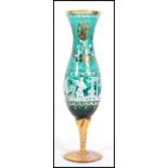 An unusual 20th century Mary Gregory type green glass and gilt cameo vase - goblet being raised on
