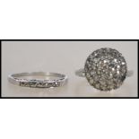 Two silver and marcasite ladies dress rings, one being hallmarked silver the other marked silver.