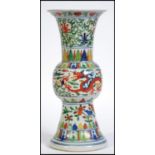 A Chinese believed 19th century Wucai five colour gu vase having dragon design with foliate