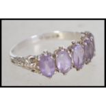 A 9ct white gold and hallmarked ladies amethyst set 5 stone ring being claw mounted on a gypsy