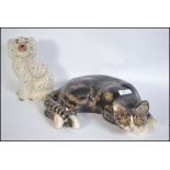 A 20th century Kensington pottery recumbent Tabby cat by Winstanley marked to base together with a