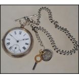 A silver hallmarked open faced pocket watch with heavy linked albert chain, t-bar and fob. The key