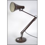 A 20th century retro Herbert Terry Anglepoise desk lamp having a circular base with conical shade in