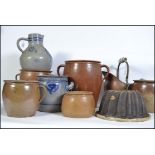 An interesting group of eight German ceramic pots/jugs/vases of various sizes three of which are