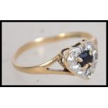 A 9ct gold hallmarked ladies sapphire ring having central  round cut sapphire in illusion set