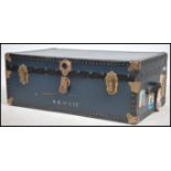 A mid century vintage large blue steamer trunk chest having clasp handles with blue panel body