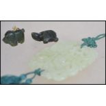 A collection of Chinese carved Jade pieces .  A large pendant carved with scrolls and flora's with a