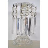 A stunning early 20th century table glass lustre having long glass faceted droplets under three
