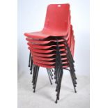 A set of 8 plastic stacking chairs by Robin Day. The cast seat frames with angular legs and elbow