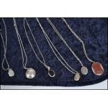 A collection of 6 ladies necklace chains with lockets / pendants. To include oval chase decorated