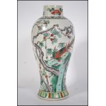 A Chinese vase believed 19th century being decorated with scenes peony tree's and asiatic pheasants.
