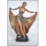 A 1930's Art Deco plaster figurine of a dancing lady being raised on a plinth base with inscribed RD