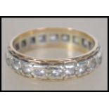 A 9ct white gold eternity ring stamped to the inside for London 1973 with makers mark for B.K.T