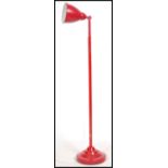 A Herbert Terry anglepoise desk lamp raised on terraced base together with a contemporary red