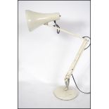 A 20th century retro Herbert Terry Anglepoise desk lamp having a circular base with conical shade in