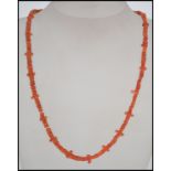 A vintage red branch coral necklace with yellow metal clasp together with another coral necklace