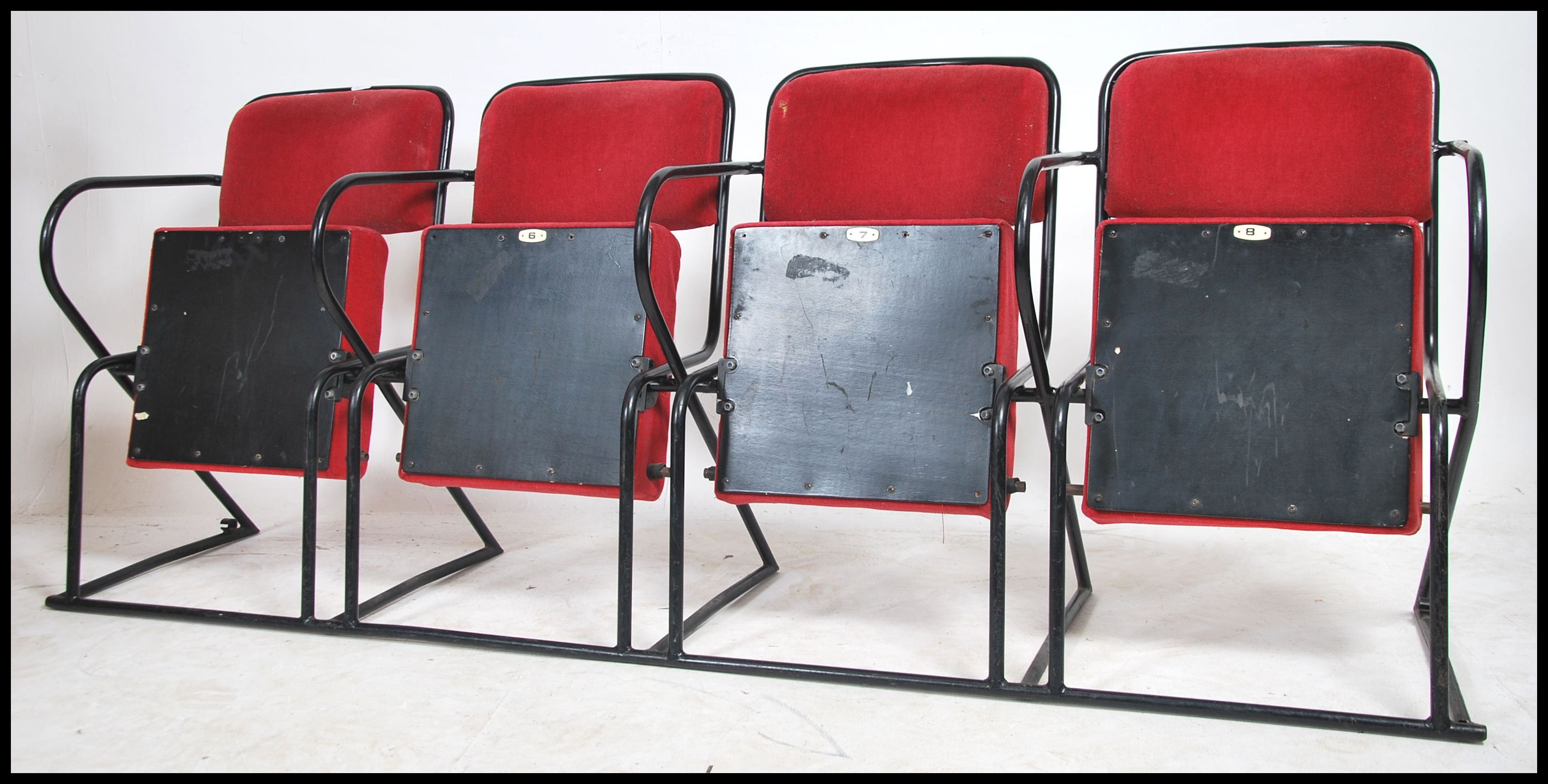 A set of 4 - run of 4 retro 20th century folding cinema chairs upholstered in red moquette fabric