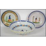 A collection of 19th and 20th century French Quimper ware ceramics to include bowls, jugs, dishes