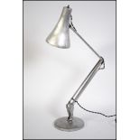 A polished metal post war  - 1950's stripped metal anglepoise Industrial desk lamp raised on a