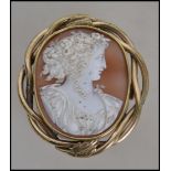 A late 19th century yellow metal mounted cameo brooch of Flora, mounted in a pinch-beck surround.