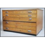 A mid century oak architects plan chest of drawers. The large body with an upright bank of drawers