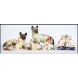 A collection of Beswick and Royal Doulton cat figurines to include Siamese, Beswick No 1559. Also