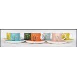 A retro Susie Cooper ceramic part tea service having a multi-coloured design and marked to the base.