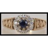 A hallmarked 9ct gold ladies sapphire and diamond ring having a central sapphire with a halo of