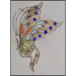 A silver filigree vintage butterfly brooch from the mid 20th century. The wings are decorated in